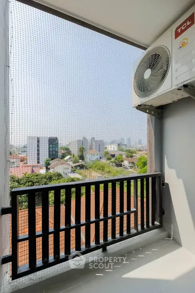 Charming balcony with city view and air conditioning unit, perfect for urban living.