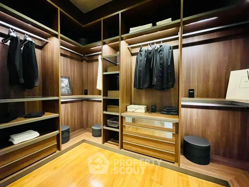 Luxurious walk-in closet with elegant wooden finishes and ample storage space.