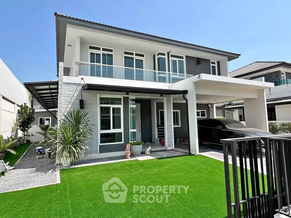 Modern two-story house with spacious driveway and lush green lawn in a serene neighborhood.