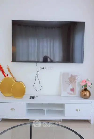 Modern living room with wall-mounted TV and stylish decor