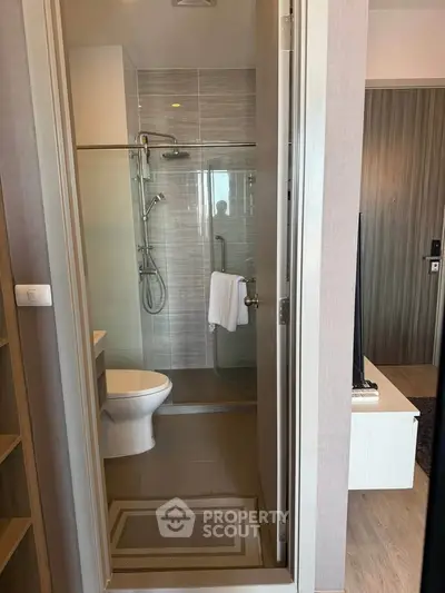Modern bathroom with glass shower and sleek design in a contemporary apartment.