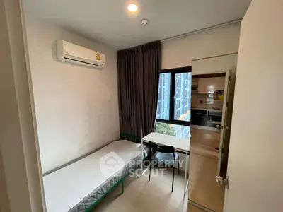 Cozy bedroom with air conditioning and study desk, ideal for urban living.