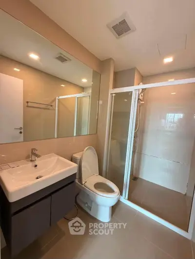 Modern bathroom with sleek fixtures and glass shower enclosure