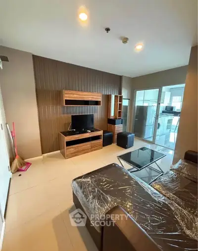Modern living room with sleek furniture and open kitchen layout