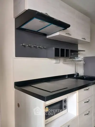 Modern kitchen with sleek cabinetry and built-in appliances, featuring a minimalist design and efficient layout.