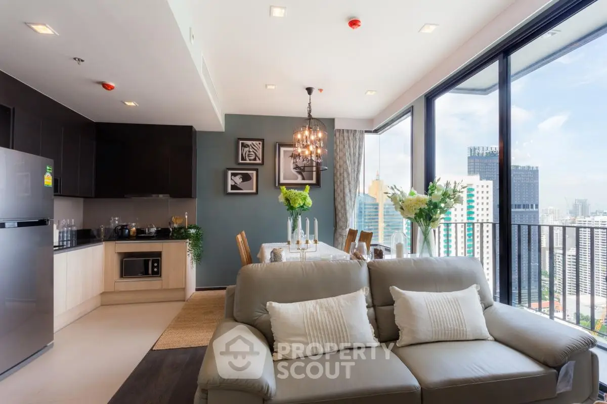 Modern open-plan living room with city view, featuring sleek kitchen and elegant dining area.