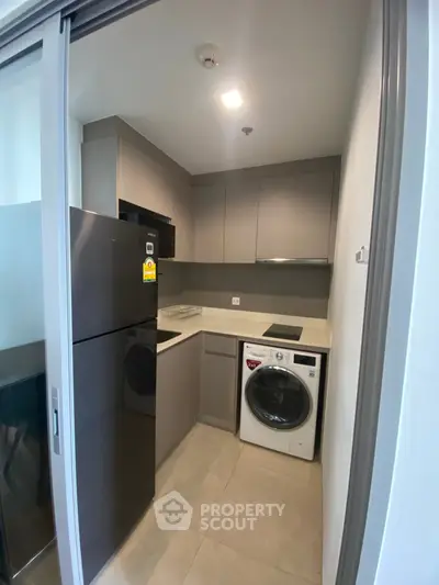 Modern compact kitchen with sleek appliances and efficient layout