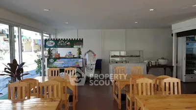 Spacious dining area with wooden tables and chairs, ideal for a cozy restaurant setup.