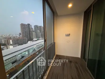 Spacious balcony with city view in modern high-rise apartment