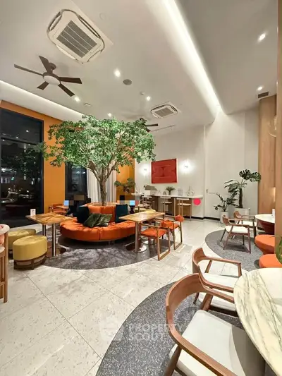 Modern interior with stylish seating and vibrant decor in a spacious lounge area.