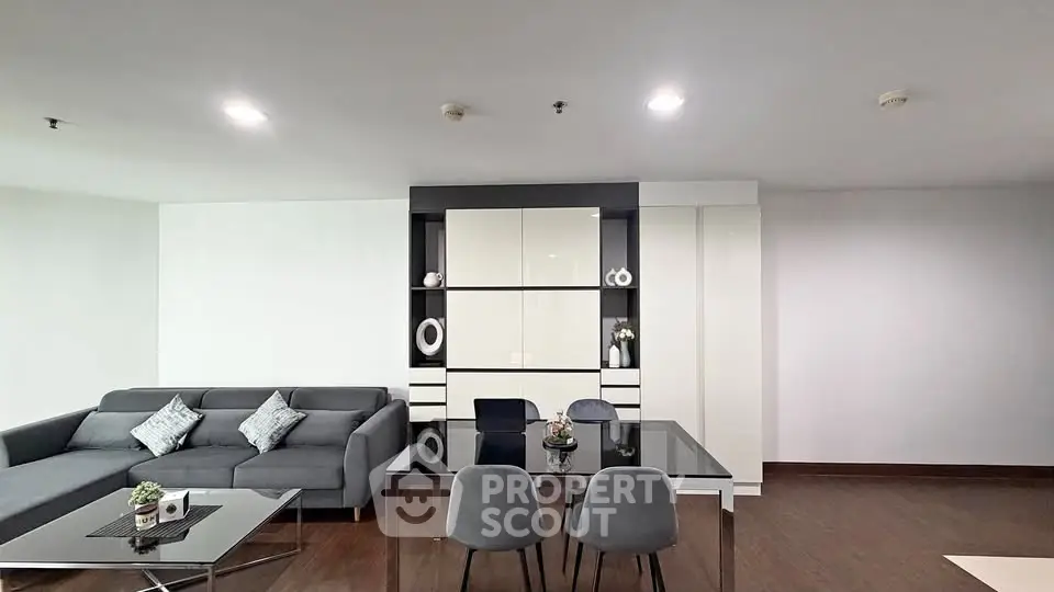 Modern living room with sleek furniture and elegant decor in a spacious apartment.