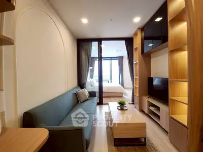 Modern living room with stylish furniture and open view to bedroom