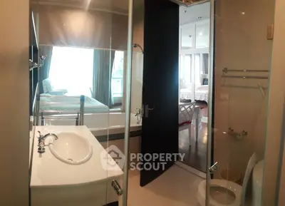 Modern bathroom with glass shower and sleek fixtures in luxury apartment