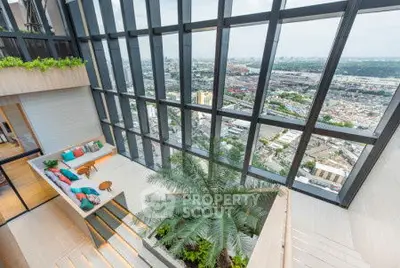 Stunning penthouse with floor-to-ceiling windows and panoramic city views.