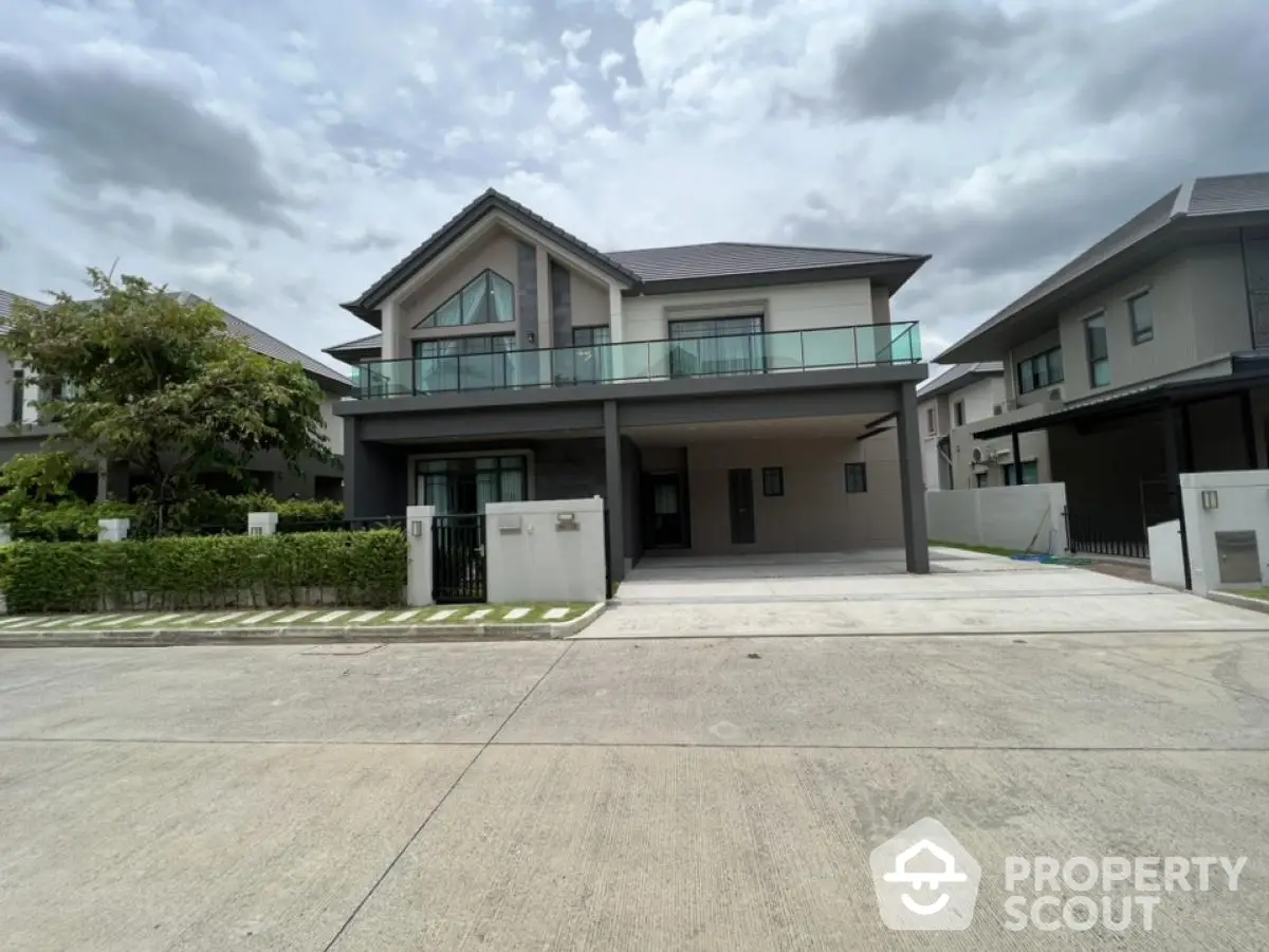 Modern two-story house with spacious driveway and contemporary design in a serene neighborhood.