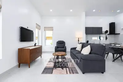 Modern living room with sleek furniture and open kitchen layout
