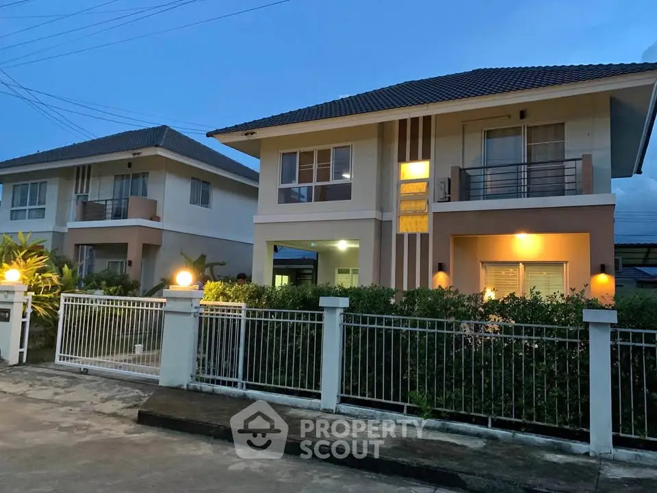 Charming two-story house with modern design and well-lit exterior at dusk.