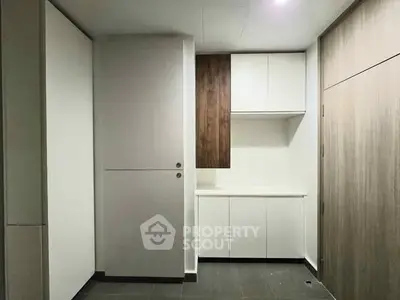 Modern minimalist kitchen with sleek cabinetry and neutral tones