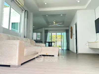 Spacious modern living room with large windows and stylish decor
