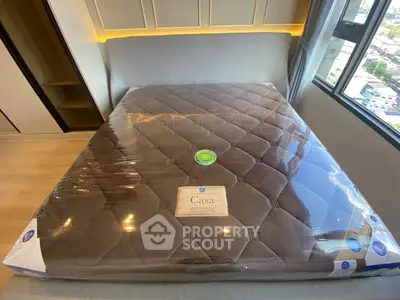 Modern bedroom with new mattress and city view window