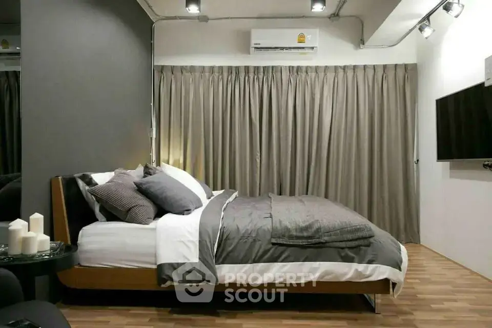 Modern bedroom with stylish decor and cozy ambiance, featuring a sleek bed and contemporary lighting.