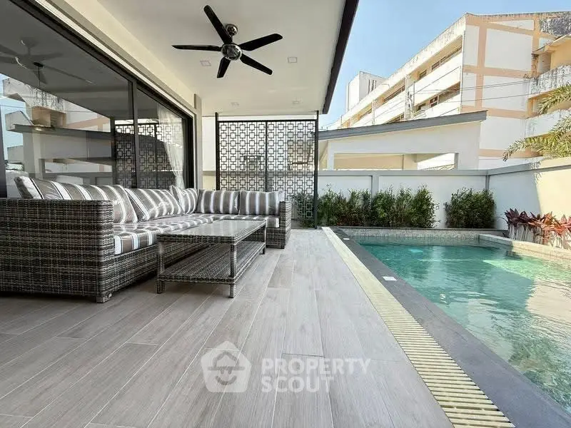 Luxurious poolside patio with modern furniture and stylish design