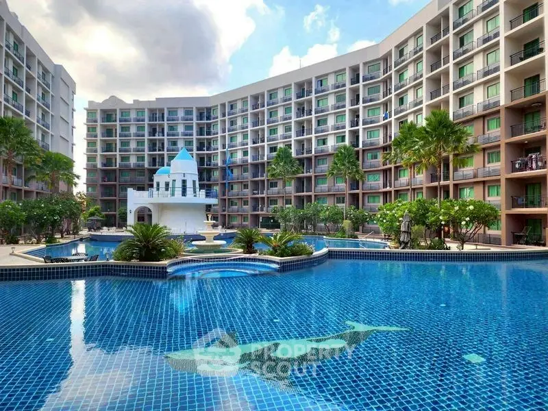 Luxurious apartment complex with stunning pool and modern architecture.