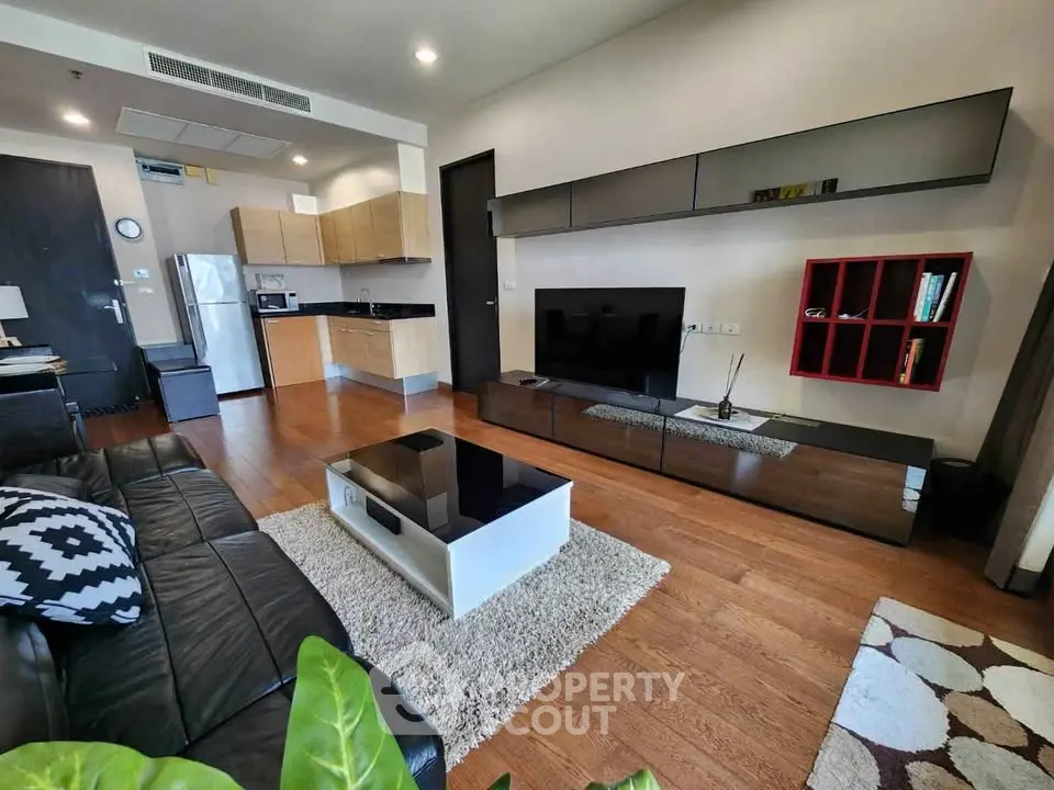 Modern living room with sleek furniture and open kitchen layout