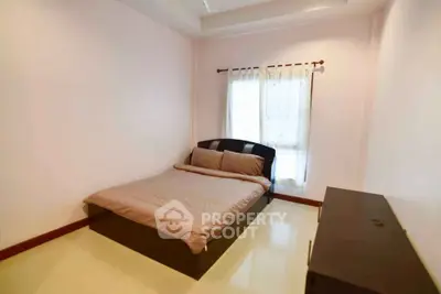 Cozy bedroom with natural light and minimalist decor, perfect for relaxation.