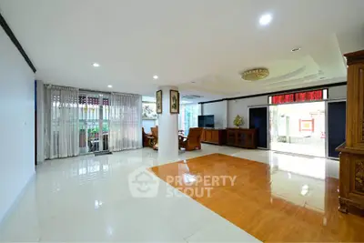 Spacious living room with elegant wooden flooring and stylish furniture