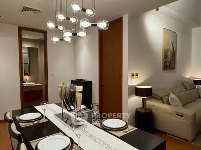 Elegant dining and living area with modern lighting and cozy ambiance