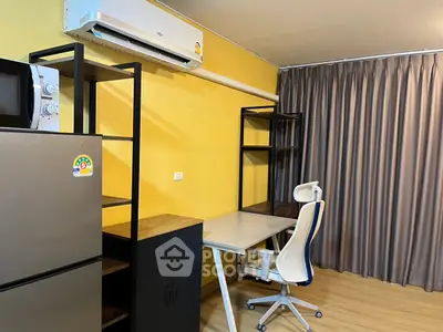 Modern study room with desk, chair, and appliances in a vibrant yellow interior.