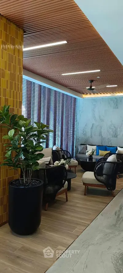 Modern living room with stylish furniture and wooden ceiling accents