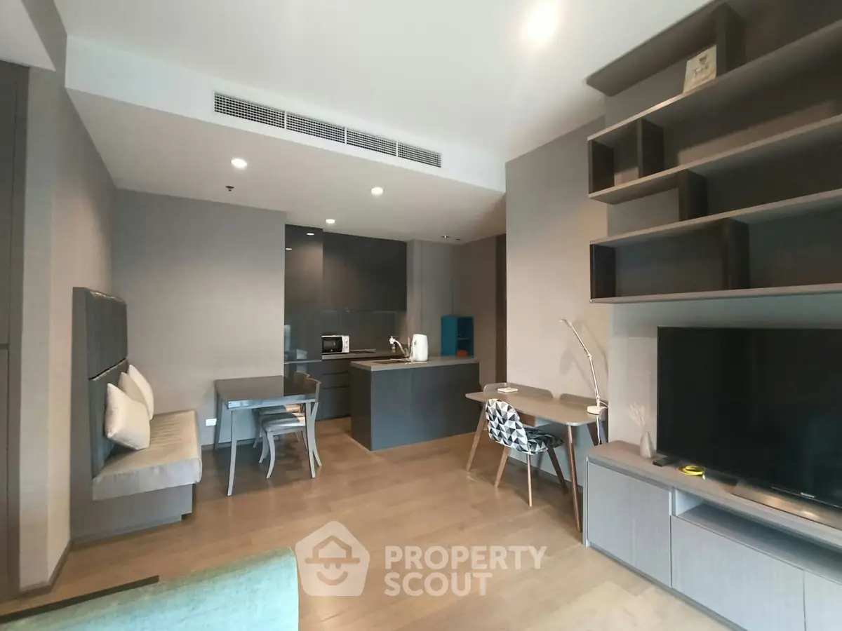 Modern open-layout living room with sleek kitchen and stylish furniture