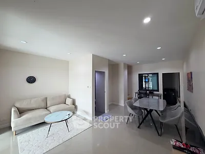 Modern living room with sleek furniture and dining area, perfect for entertaining.