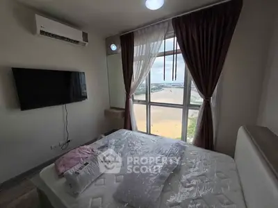 Cozy bedroom with large window offering stunning city view, featuring wall-mounted TV and air conditioning.