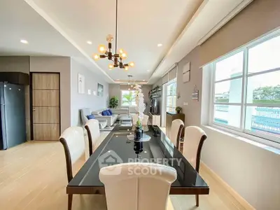 Spacious modern dining and living area with elegant decor and large windows.
