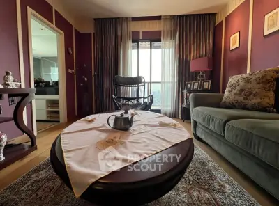 Charming living room with elegant decor and large window offering natural light.