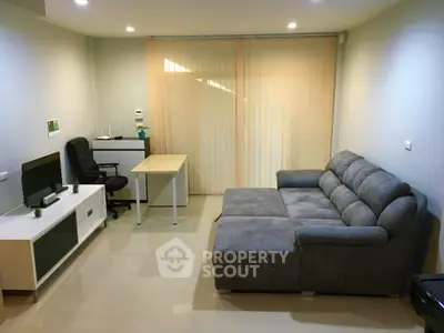 Modern living room with cozy gray sofa and sleek entertainment setup