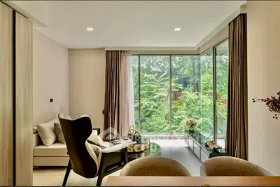 Modern living room with large windows and lush garden view, featuring stylish furniture and elegant decor.