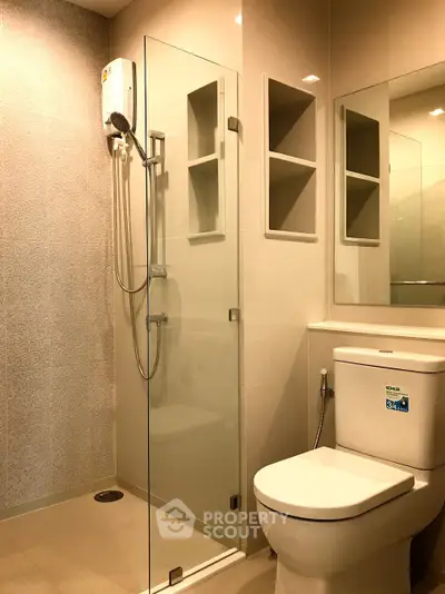 Modern bathroom with glass shower enclosure and sleek fixtures