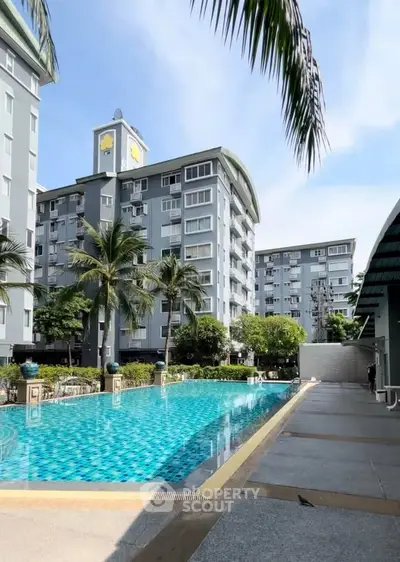 Luxurious apartment complex with a stunning outdoor pool and lush greenery, perfect for relaxation and leisure.