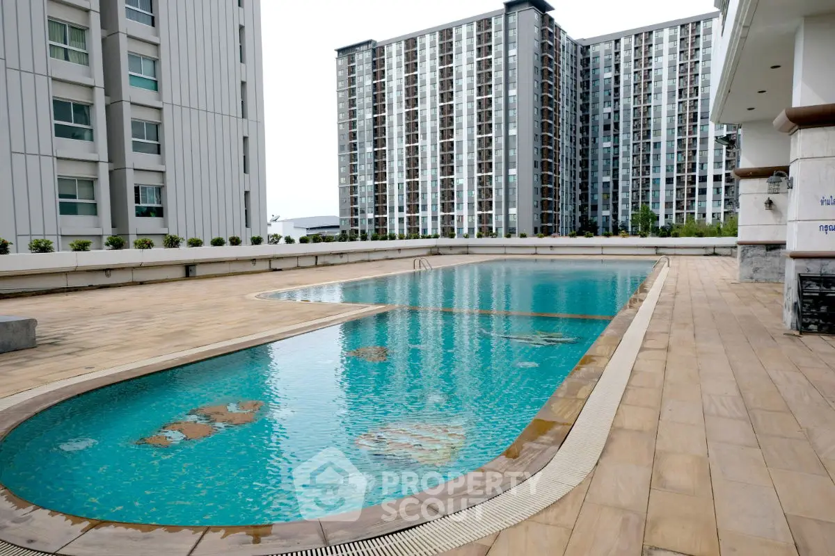Luxurious rooftop pool with stunning city views in modern high-rise building.