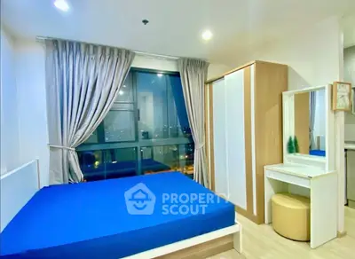 Modern bedroom with large window and stylish furniture in urban apartment