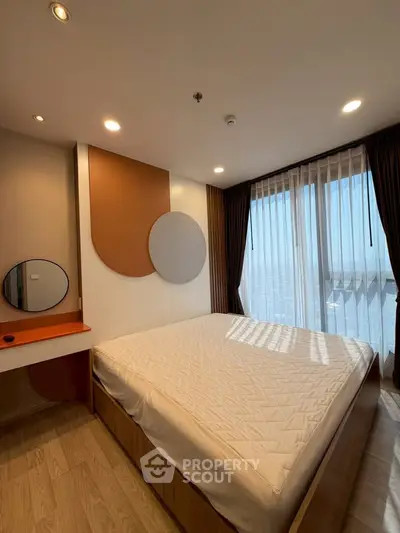 Modern bedroom with stylish decor and large window offering stunning city views.