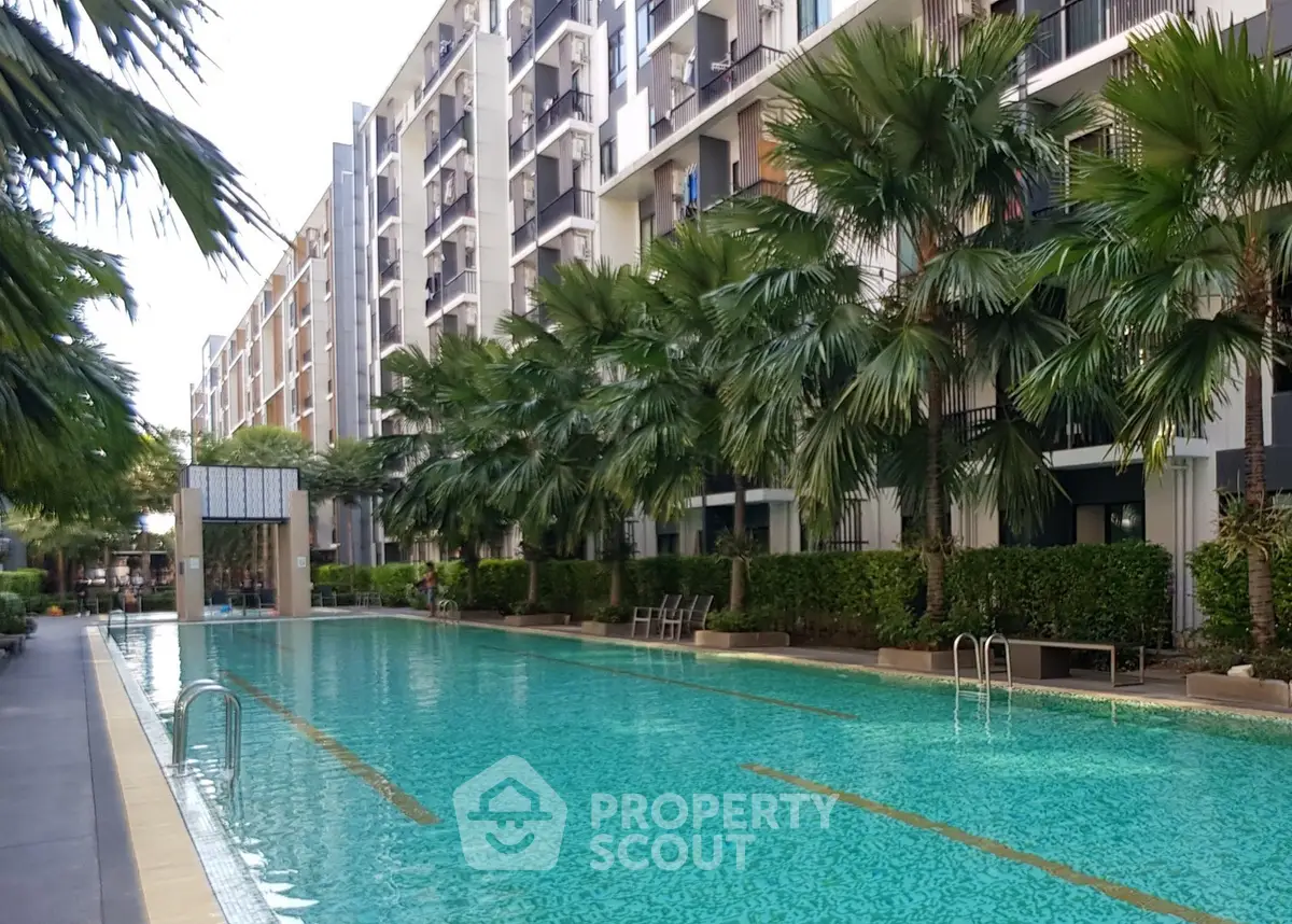 Luxurious apartment complex with a stunning outdoor pool and lush greenery, perfect for relaxation and leisure.