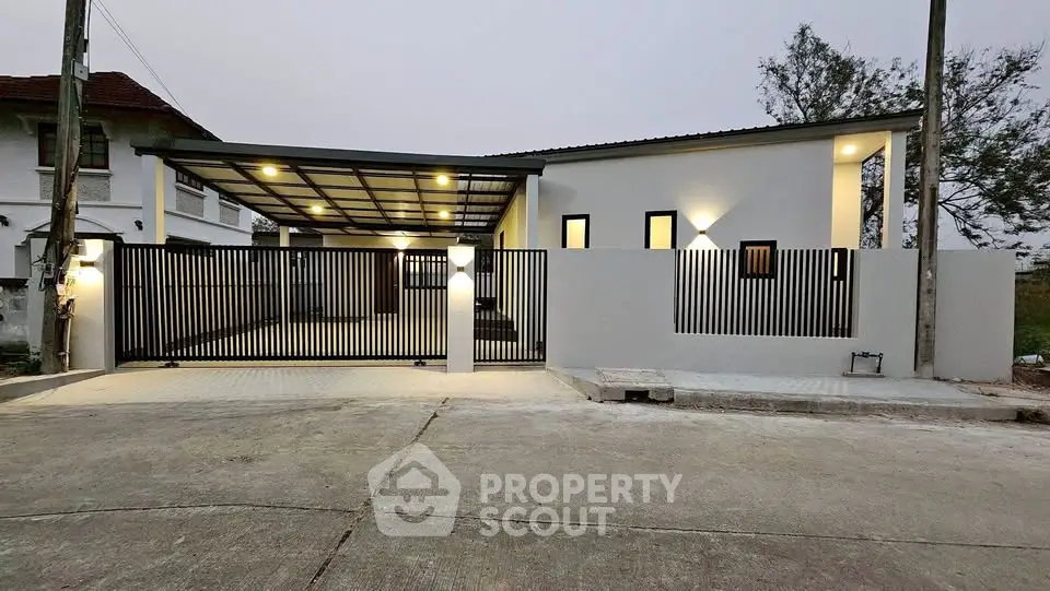 Modern minimalist house with sleek gate and ambient lighting