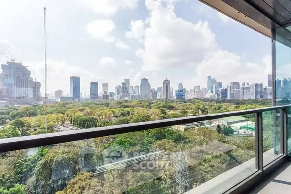 Stunning cityscape view from a modern balcony overlooking lush greenery and skyline.