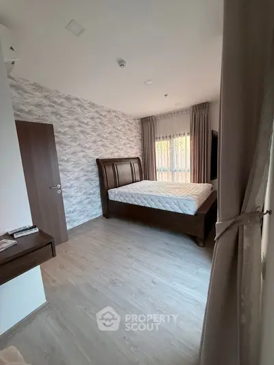 Spacious bedroom with elegant wooden bed and modern decor