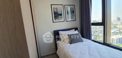 Cozy bedroom with city view, modern decor, and ample natural light